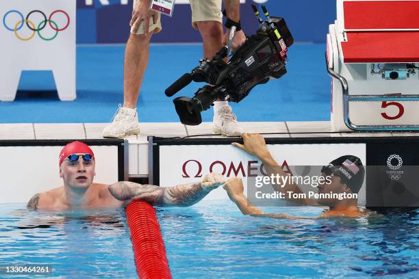 Adam Peaty of Team Great Britain and Michael Andrew of Team United States celebrate after competing in the Men's 100m Breaststroke Semifinal on day...