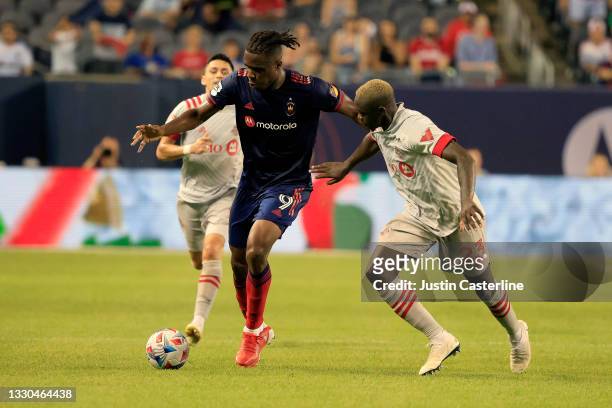 Chinonso Offor of Chicago Fire makes a move on Chris Mavinga of Toronto FC at Soldier Field on July 24, 2021 in Chicago, Illinois.