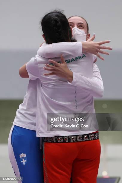 Antoaneta Kostadinova of Team Bulgaria and Anna Korakaki of Team Greece embrace follwing the 10m Air Pistol Women's event on day two of the Tokyo...