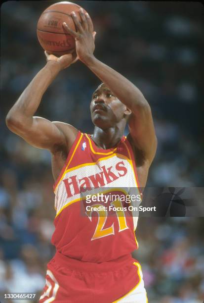 Dominique Wilkins of the Atlanta Hawks stands at the line to shoot a foul shot against the Washington Bullets during an NBA basketball game circa...