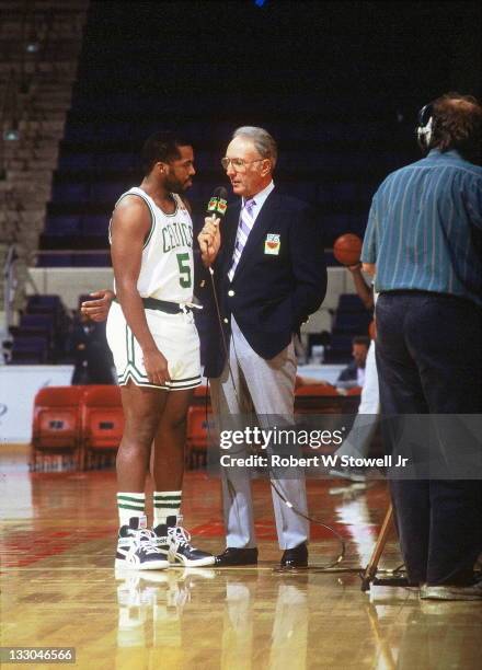 Boston Celtic great Bob Cousy, in blue blazer, interviews Celtic point guard John Bagley during a pre-game report, Hartford, CT, 1992.