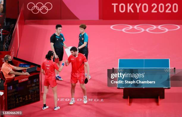 Emmanuel Lebesson and Yuan Jia Nan of Team France fist bump after winning their Mixed Doubles Quarterfinal match against Wong Chun Ting and Doo Hoi...