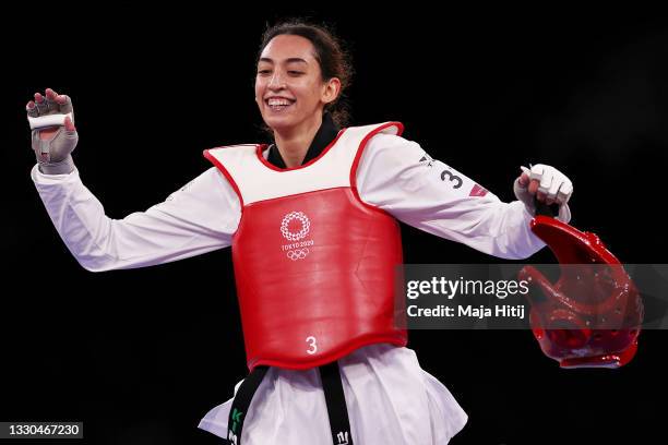 Kimia Alizadeh Zonouzi of IOC Refugee Team celebrates after defeating Jade Jones of Team Great Britain during the Women's -57kg Taekwondo Round of 16...