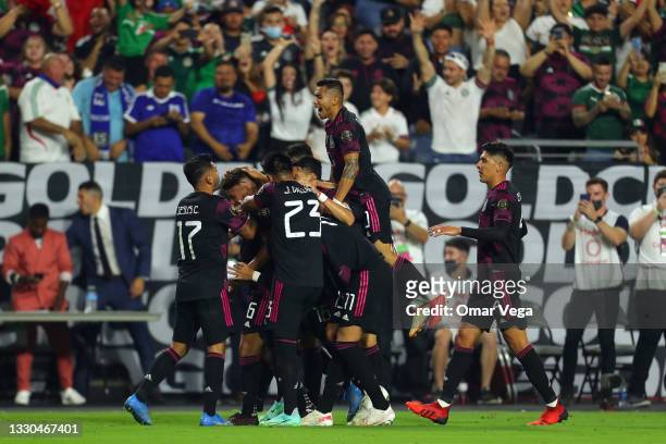 Jonathan Dos Santos of Mexico celebrates with his teammates after scoring his team's second goal during to the a quarterfinal match between Mexico...
