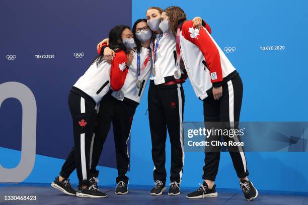 Kayla Sanchez, Margaret Macneil, Rebecca Smith and Penny Oleksiak of Team Canada pose after winning the silver medal in the Women's 4 x 100m...