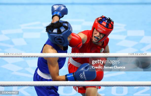 Roumaysa Boualam of Algeria exchanges punches with Jutamas Jitpong of Thailand during the Women's Fly on day two of the Tokyo 2020 Olympic Games at...