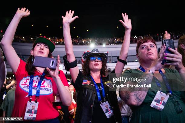 People stand in admiration as former U.S. President Donald Trump takes the stage during the Rally To Protect Our Elections conference on July 24,...