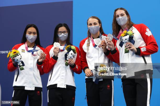 Kayla Sanchez, Margaret Macneil, Rebecca Smith and Penny Oleksiak of Team Canada pose after winning the silver medal in the Women's 4 x 100m...