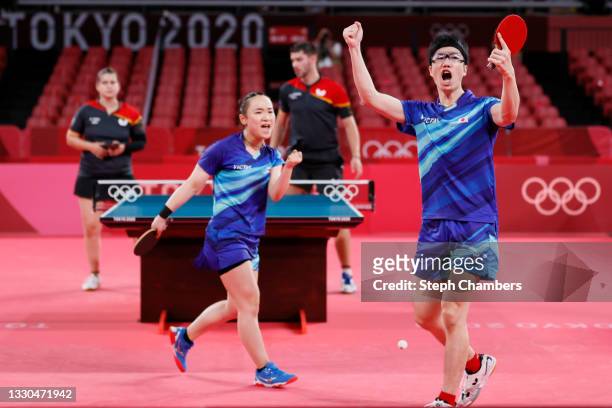 Ito Mima and Jun Mizutani of Team Japan react during their Mixed Doubles Quarterfinal match on day two of the Tokyo 2020 Olympic Games at Tokyo...