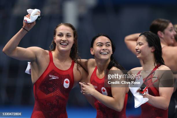 Rebecca Smith, Kayla Sanchez and Margaret MacNeil of Team Canada react after winning the silver medal in the Women's 4 x 100m Freestyle Relay Final...