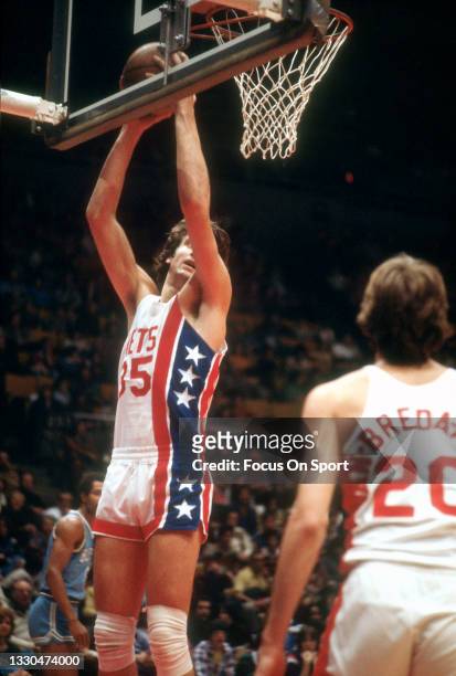 Kim Hughes of the New Jersey Nets grabs a rebound against the Buffalo Braves during an NBA basketball game circa 1976 at the Rutgers Athletic Center...