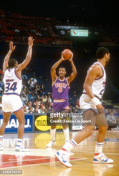 Eddie Johnson of the Phoenix Suns looks to pass the ball against the Washington Bullets during an NBA basketball game circa 1988 at the Capital...
