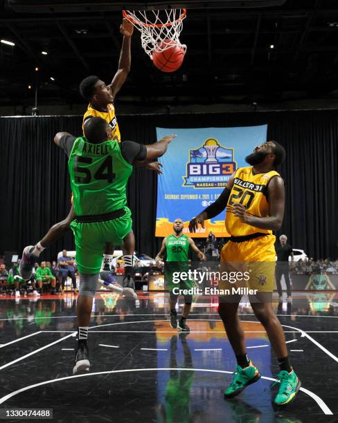 Franklin Session of Killer 3's dunks against Jason Maxiell of Aliens as Donte Green of Killer 3's looks on during the third week of the BIG3 at the...