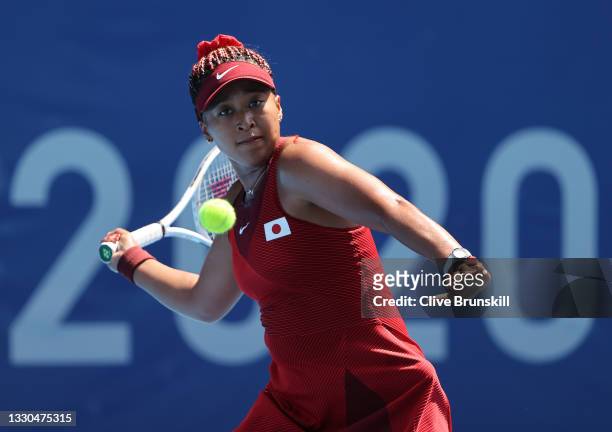 Naomi Osaka of Team Japan plays a forehand during her Women's Singles First Round match against Saisai Zheng of Team China on day two of the Tokyo...