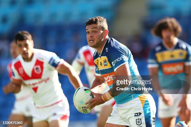 Ashley Taylor of the Titans passes during the round 19 NRL match between the St George Illawarra Dragons and the Gold Coast Titans at Cbus Super...