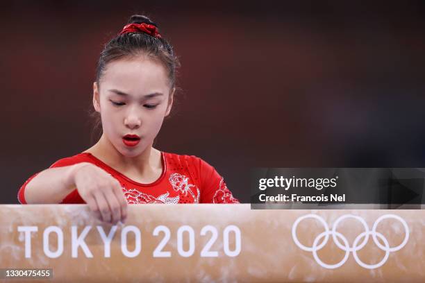 Jin Zhang of Team China marks a spot on the balance beam during Women's Qualification on day two of the Tokyo 2020 Olympic Games at Ariake Gymnastics...