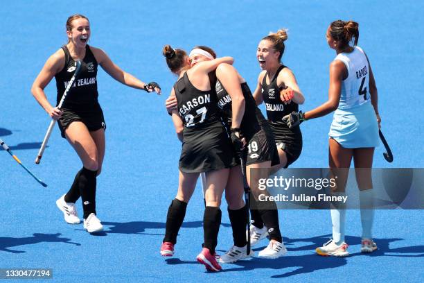Holly Pearson of Team New Zealand is congratulated by Tessa Jopp and teammates after scoring Team New Zealand's third goal during the Women's Pool B...