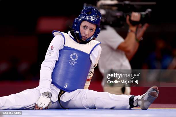 Jade Jones of Team Great Britain sits dejected after losing against Kimia Alizadeh Zonouzi of IOC Refugee Team during the Women's -57kg Taekwondo...