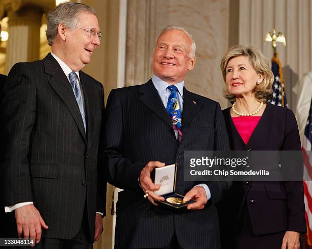 Senate Minority Leader Mitch McConnell and Sen. Kay Bailey Hutchison pose for photographs after presenting Apollo 11 Astronaut Buzz Aldrin after...