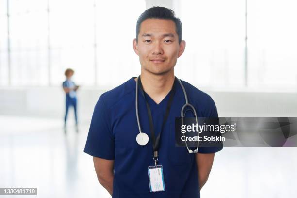 male healthcare worker, portrait - nurse portrait stock pictures, royalty-free photos & images