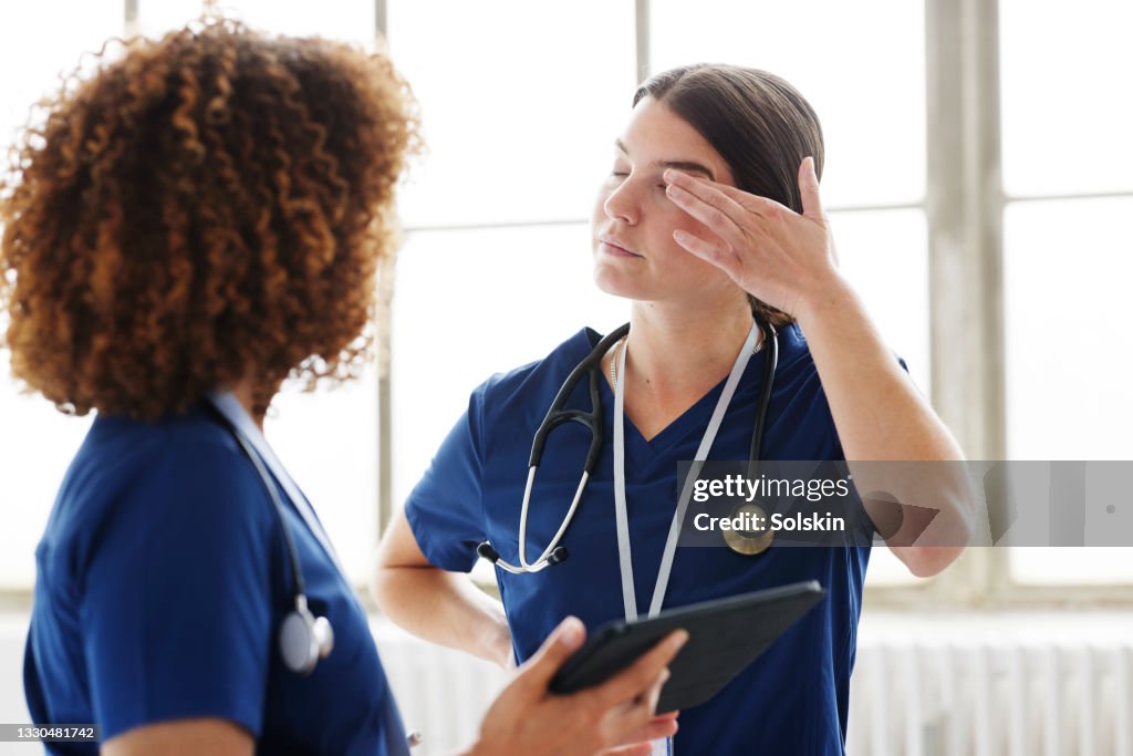 Two healthcare professionals in conversation