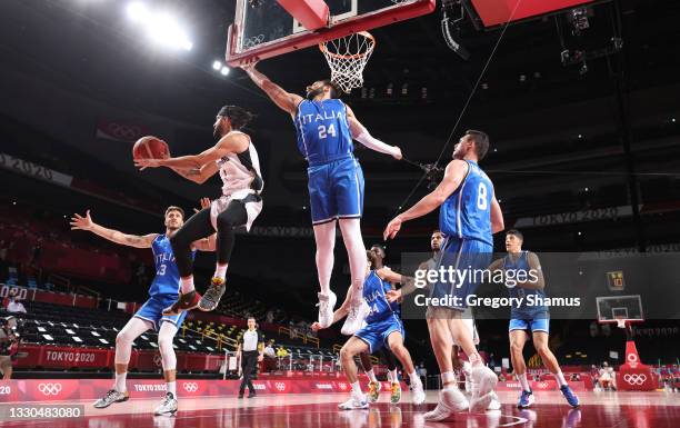 Joshiko Saibou of Team Germany passes under Riccardo Moraschini of Team Italy during the first half on day two of the Tokyo 2020 Olympic Games at...