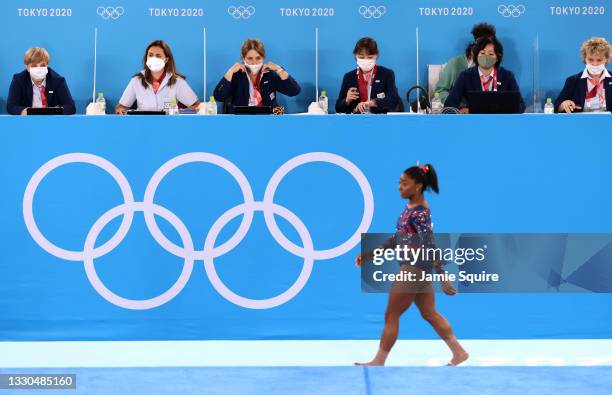 Simone Biles of Team United States walks by the judges' table during Women's Qualification on day two of the Tokyo 2020 Olympic Games at Ariake...