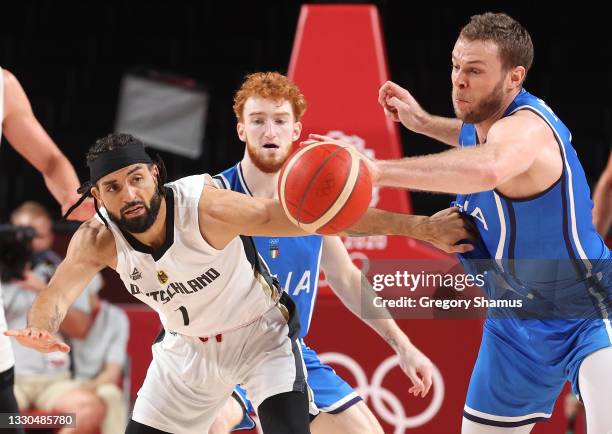 Joshiko Saibou of Team Germany and Nicolò Melli of Team Italy reach for a loose ball during the second half on day two of the Tokyo 2020 Olympic...