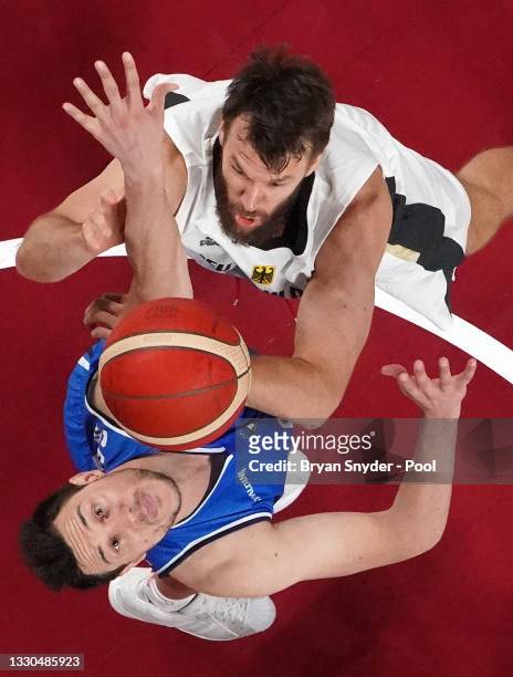 Danilo Barthel of Team Germany and Danilo Gallinari of Team Italy go after a rebound during the second half on day two of the Tokyo 2020 Olympic...