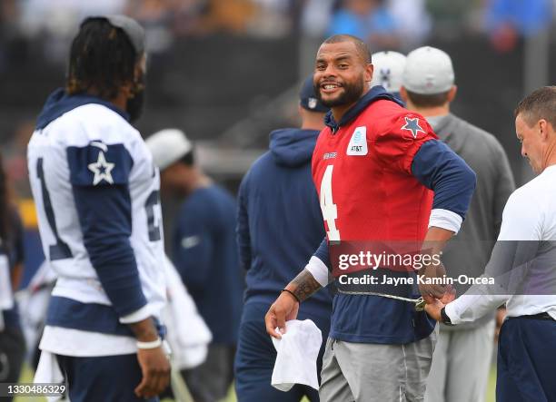 Running back Ezekiel Elliott and quarterback Dak Prescott of the Dallas Cowboys warm up before the start of training camp at River Ridge Complex on...