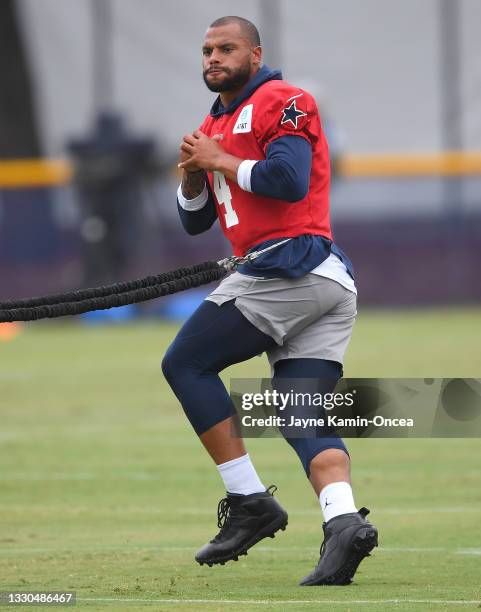 Quarterback Dak Prescott of the Dallas Cowboys warms up before the start of training camp at River Ridge Complex on July 24, 2021 in Oxnard,...