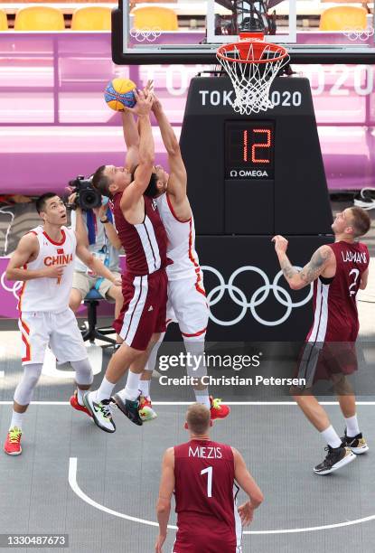 Agnis Cavars of Team Latvia competes for the ball against Haonan Li of Team China during the Men's Pool Round match between China and Latvia on day...