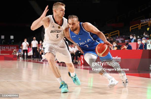 Stefano Tonut of Team Italy drives to the basket against Niels Giffey of Team Germany during the second half on day two of the Tokyo 2020 Olympic...