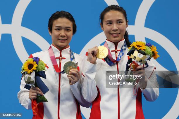 Tingmao Shi and Han Wang of Team China pose with the gold medals on the podium during the medal ceremony for the Women's 3m Springboard Finals on day...