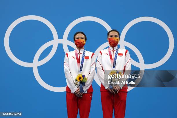 Tingmao Shi and Han Wang of Team China pose with the gold medals on the podium during the medal ceremony for the Women's 3m Springboard Finals on day...