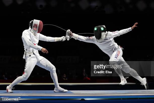 Sangyoung Park of Team South Korea gets a point hit on Kazuyasu Minobe of Team Japan in Men's Individual Épée third round on day two of the Tokyo...