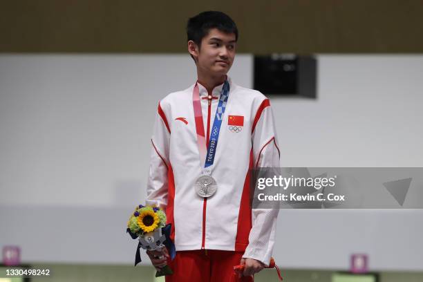 Silver Medalist Lihao Sheng of Team China poses on the podium during the medal ceremony of the 10m Air Rifle Men's event on day two of the Tokyo 2020...