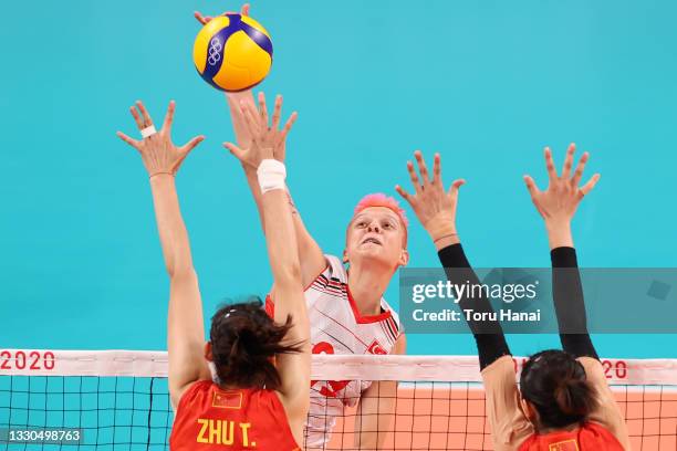 Ebrar Karakurt of Team Turkey attempts to hit over the Team China defense during the Women's Preliminary - Pool B on day two of the Tokyo 2020...