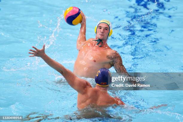 Aaron Younger of Team Australia is challenged by Vlado Popadic of Team Montenegro during the Men's Preliminary Round Group B match between Australia...