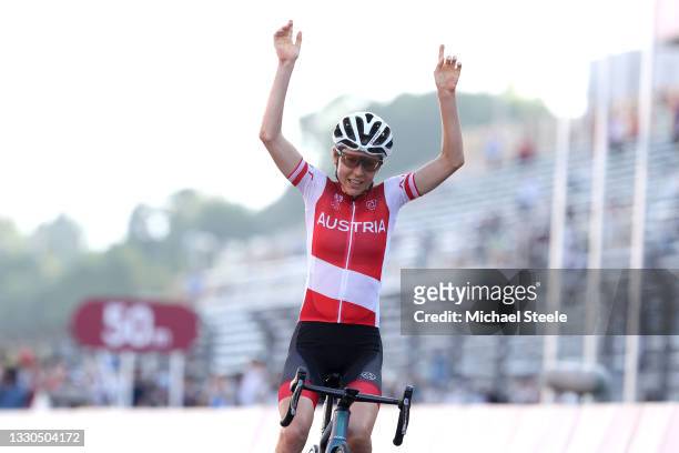 Anna Kiesenhofer of Team Austria celebrates winning the gold medal during the Women's road race on day two of the Tokyo 2020 Olympic Games at Fuji...