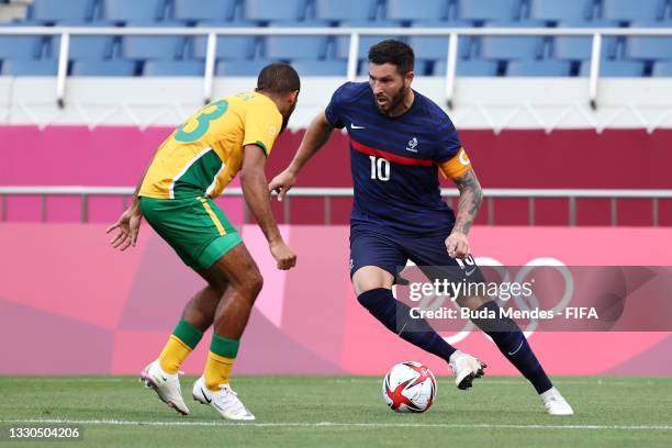 Andre-Pierre Gignac of Team France battles for possession with Reeve Frosler of Team South Africa during the Men's First Round Group A match between...