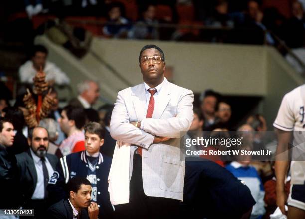 Georgetown's coach John Thompson looks on with arms crossed, during a game against UConn, at Hartford CT 1990.