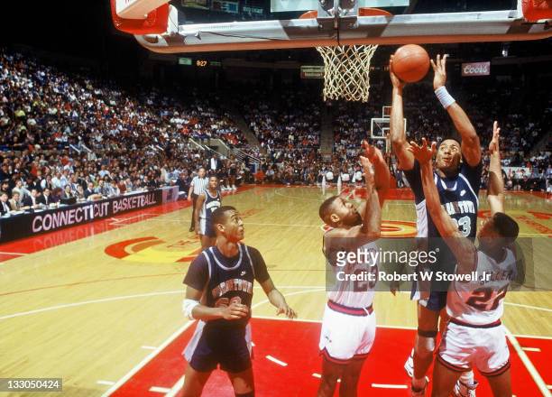 Georgetown's Alonzo Mournng takes it to the hole against the University of Connecticut, 1990.