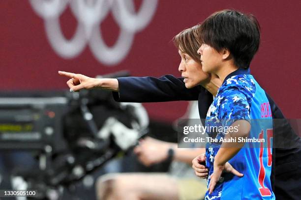 Head coach Asako Takakura of Japan gives instruction to Yuka Momiki during the Women's First Round Group E match between Japan and Great Britain on...