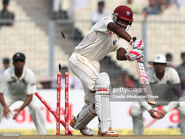 Darren Bravo of West Indies is bowled by Umesh Yadav of India during the third day of second Test Match between India and West Indies at Eden Gardens...