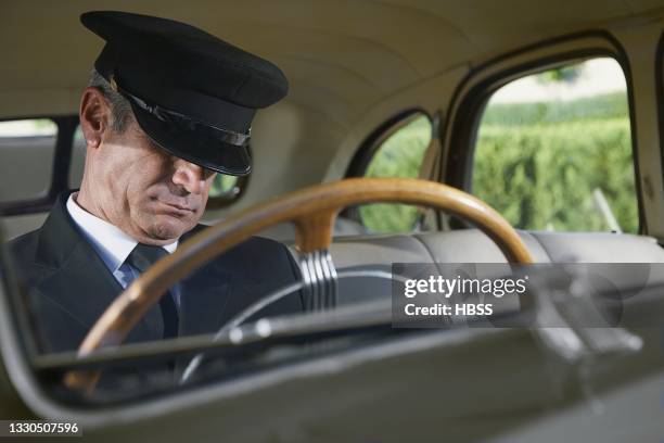 chauffeur napping in a vintage car - man sleeping with cap stock pictures, royalty-free photos & images