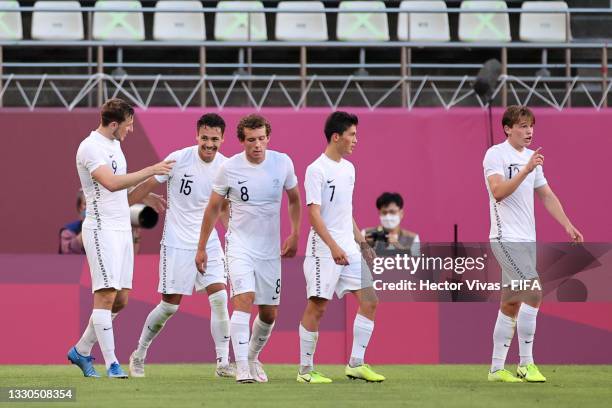 Chris Wood of Team New Zealand celebrates with teammates after scoring their side's second goal during the Men's First Round Group B match between...