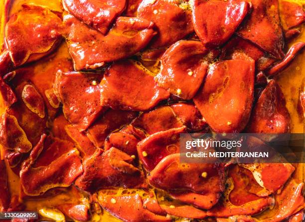 roasted red peppers in olive oil macro full frame texture - roasted pepper stock pictures, royalty-free photos & images