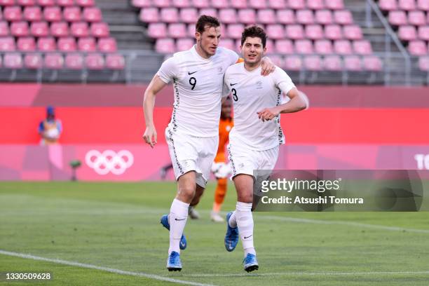 Chris Wood of Team New Zealand celebrates with teammate Liberato Cacace after scoring their side's second goal during the Men's First Round Group B...