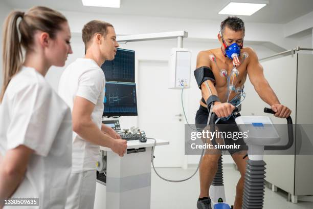 man taking a cardiopulmonary stress test in clinic - stress test stock pictures, royalty-free photos & images